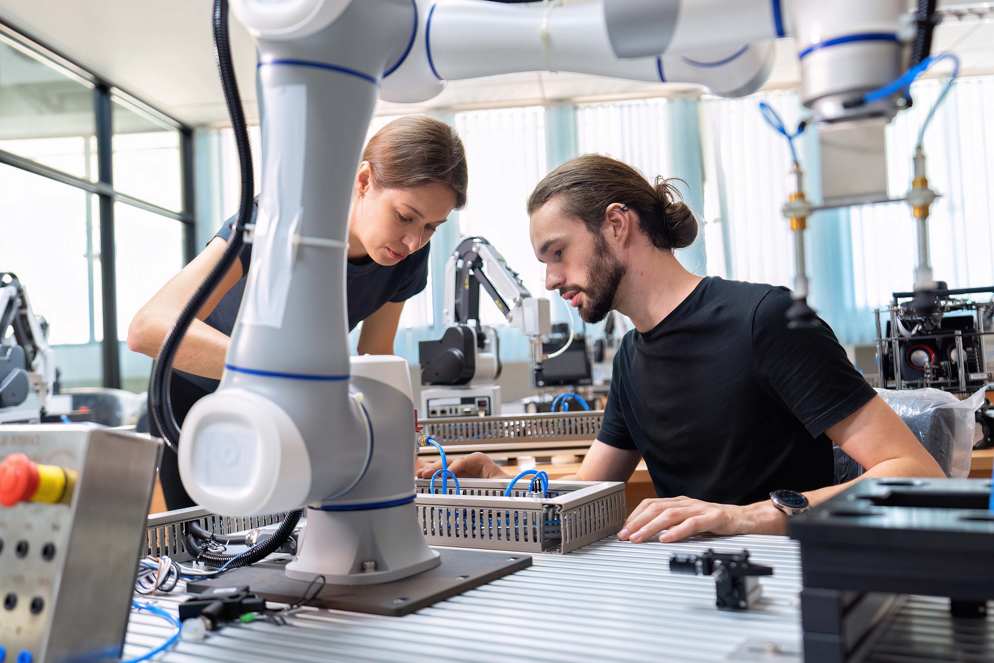 Een ingenieur in onderzoeksontwikkeling robotfabriek controleert prototype van automatiseringsrobotarm